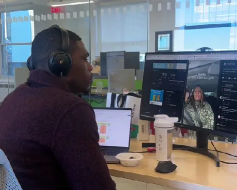 Professional worker watching one of Reesa Teesa's videos that went viral on TikTok at his office desk