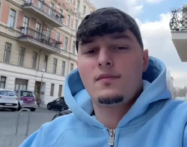 Nikolai Savic records himself before showing a transition from a powdered sugar cake to snowy montains